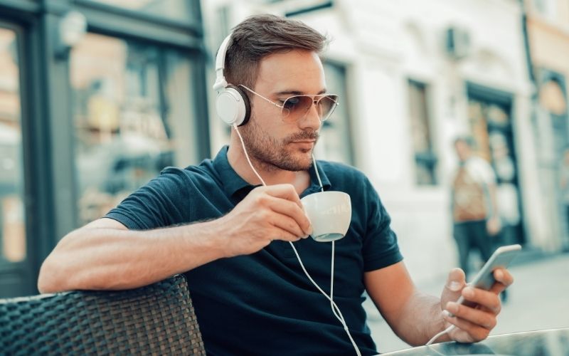 Man listening to music while having coffee