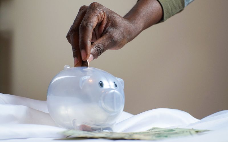 A person saving money in a piggy bank
